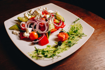 Stock Photo - Tasty vegetable salad with grilled chicken on a white plate