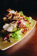 Stock Photo - Tasty vegetable salad with grilled chicken on a white plate