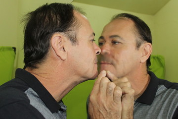 Man kissing a mirror