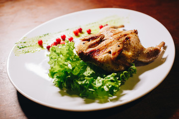Stock Photo - Grilled fried roast Chicken Tabaka on a white plate