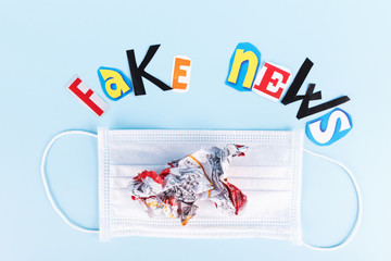 L'insciption Fake news, collage of colored paper's letters, with medical face mask. The concept of...