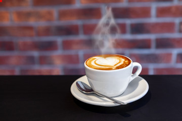 A cup of coffee on a with heart, valentines day, red wall