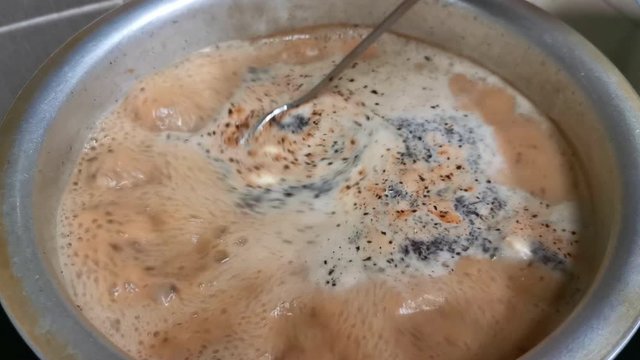Traditional  massala chai (tea) boiling in a pot. 