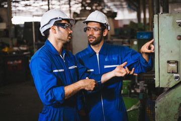 Group of Industrial factory maintenance engineers inspect relay protection system of machinery....