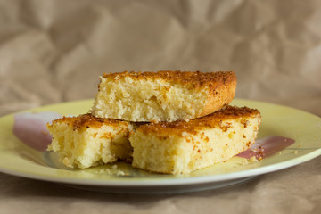 Pieces of baked mannik semolina casserole on yellow plate