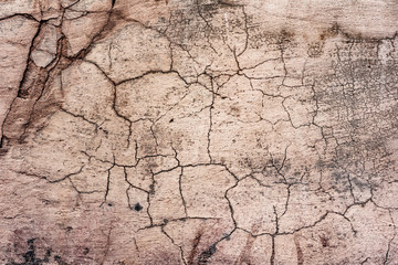 Texture of a concrete wall with cracks and scratches which can be used as a background