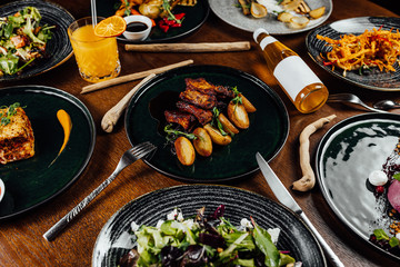 Fresh and delicious grilled pork ribs with fried potatoes on table