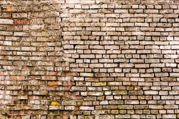 Texture of a brick wall with cracks and scratches which can be used as a background
