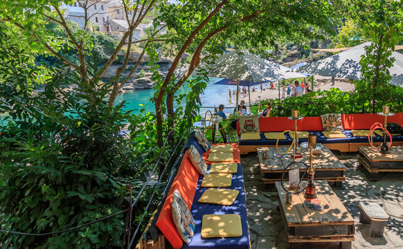 MOSTAR, BOSNIA HERZEGOVINA - 2017 AUGUST 16. Cafe on the banks of the Neretva River.