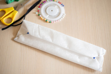 home-made masks; hand-made face masks; blank masks folded for sewing elastic bands