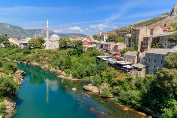 Fototapeta na wymiar MOSTAR, BOSNIA HERZEGOVINA - 2017 AUGUST 16. Koski Mehmed Pasha Mosque dating to the 17th century, with striking views of the Neretva River.