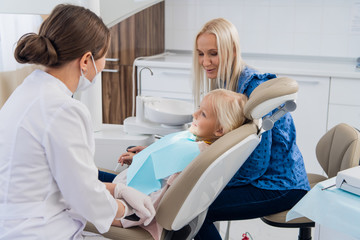 A child having a dental checkup with her mother