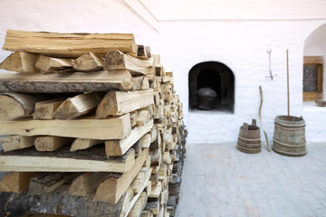 Russian Russian woodpile on the background of a bleached stove, Russian bath, barrels of water