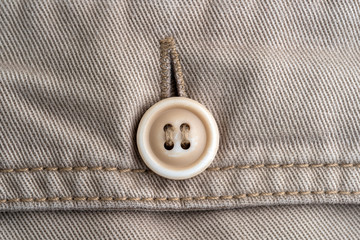 Trouser pocket with button, closeup. Backside view with buttoned pocketon the pants