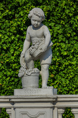 Fototapeta na wymiar Sculptures in the public garden of Belvedere. Belvedere Palace was summer residence for Prince Eugene of Savoy. Vienna, Austria.