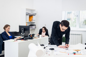 Young Male architect working on a project in a bright spacious office