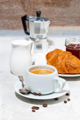 breakfast with espresso and croissants with berry jam