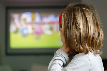 Little girl watching cartoons at home