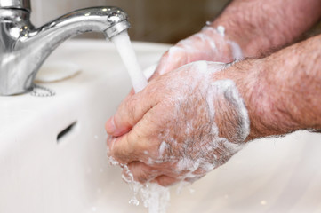Close up of Senior man washing his hands using soap foam, Prevention from covid19, Coronavirus or Bacteria. Healthcare concept, 7 step hands wash .
