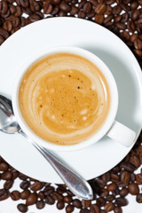 espresso cup on coffee beans, closeup