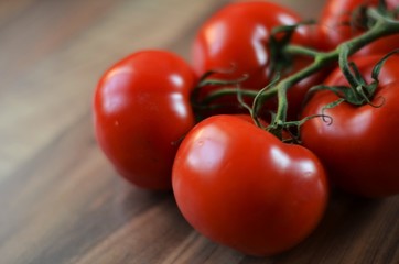 red tomatoes on a vine in the kitchen