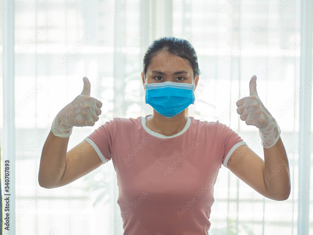 Wall mural woman wearing surgical mask for corona virus. young woman wearing medical face mask, people cleaning