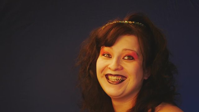 A girl with messy,tousled hair laughs.