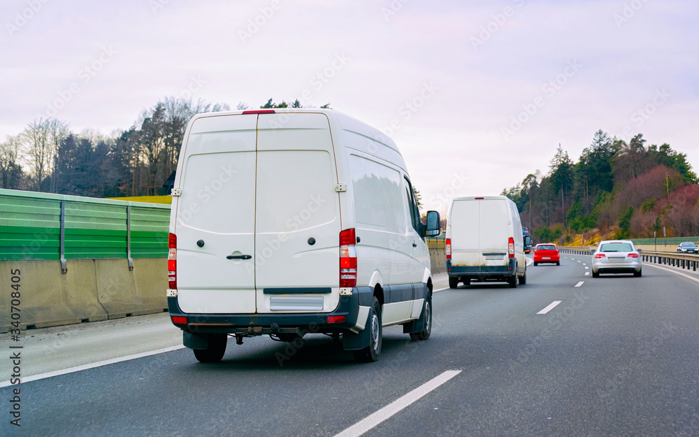 Wall mural White Minivans in road European van transport reflex