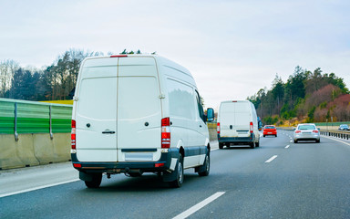 White Minivans on road reflex