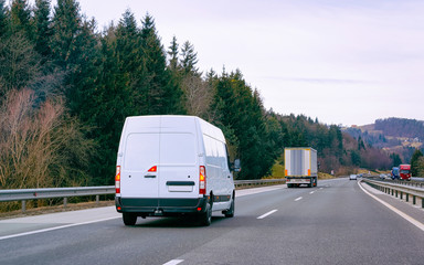 Fototapeta na wymiar White Minivans on road van transport logistics reflex