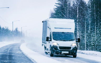 Mini van in the Snowy Winter Road in Finland Lapland reflex