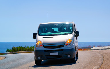 Fototapeta na wymiar Mini van in Road in Villasimius in Cagliari in Sardinia reflex