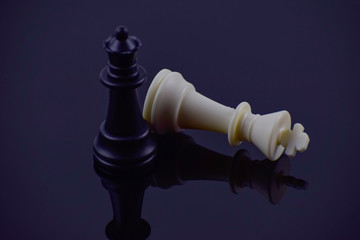 Chess pieces on a black background.