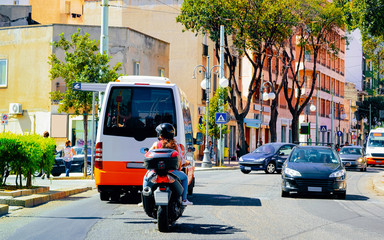 Fototapeta na wymiar Street view on Road with cars scooter shuttle bus Cagliari reflex