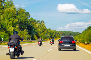 Bikers on Motorbikes on road in Switzerland reflex