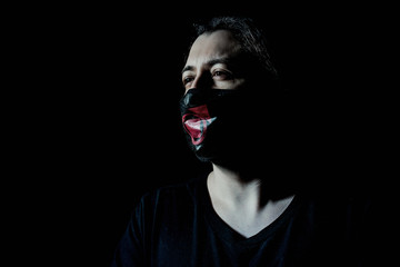 masked guy in the gloom