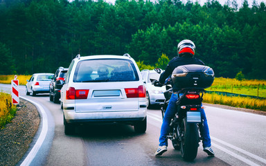 Motorcycle and cars in traffic jam on road in Poland reflex