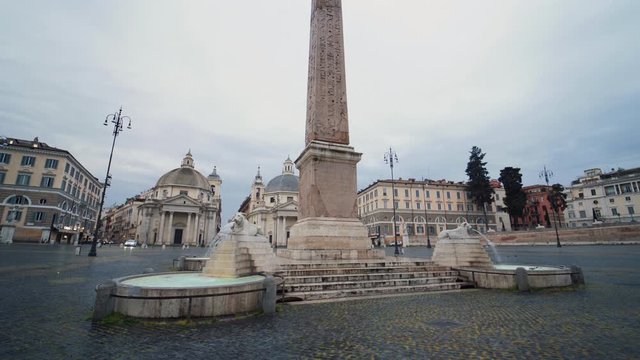 Tracking shot walking the fountain monument, on the Piazza del Popolo, quiet, overcast day in Rome, Italy - COVID-19 Outbreak