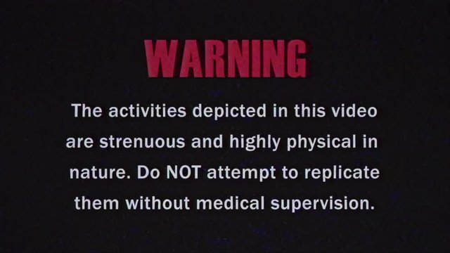 The beginning segment of a (fake) VHS old noisy tape, with intentional analog artifacts, showing a warning about the content (highly physical in nature).
