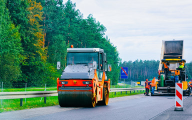Road roller on highway road in Poland reflex