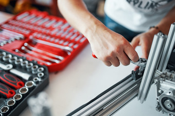 Skilled industrial worker assembling aluminum construction, set of tools, detail in indoors - 340713064