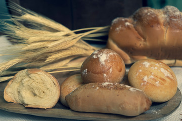 Baked breads on wooden table background.