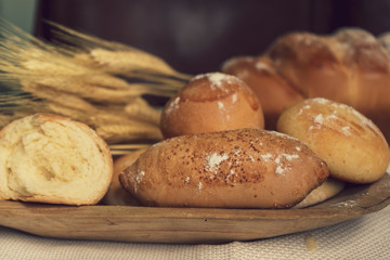 Baked breads on wooden table background.