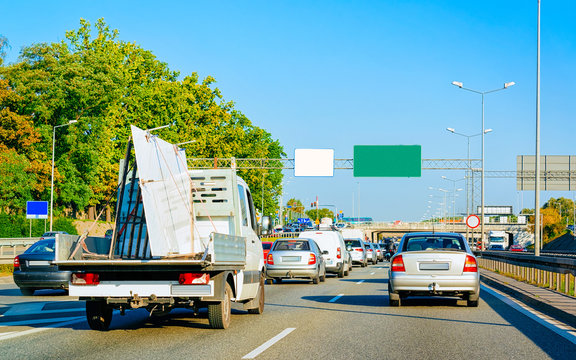 Car carrying trailer in asphalt road of Slovenia reflex