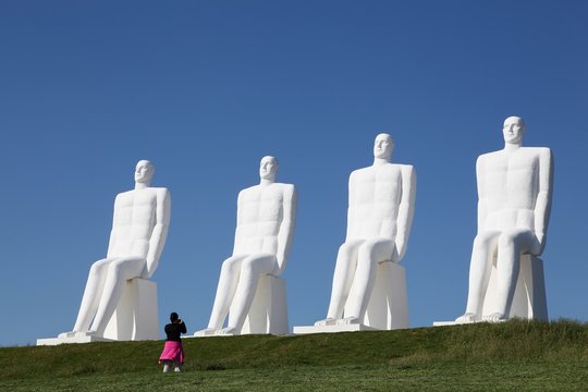 Esbjerg, Denmark - June 11, 2015: The sculpture "Men at sea" in Esbjerg, Denmark. The 4 men looking at the sea are made in white concrete by the danish artist Svend Wiig Hansen