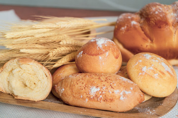 Baked breads on wooden table background.