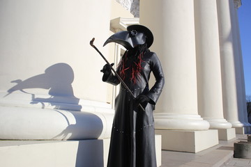 Costume plague doctor in the city streets