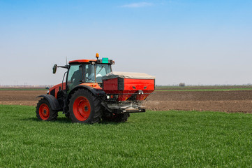 Tractor spreading artificial fertilizers