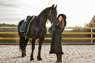 Pretty young girl with the horse