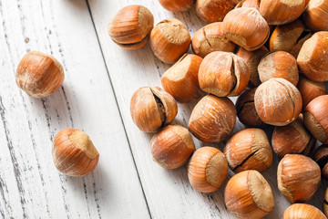 Hazelnut nuts on a white board